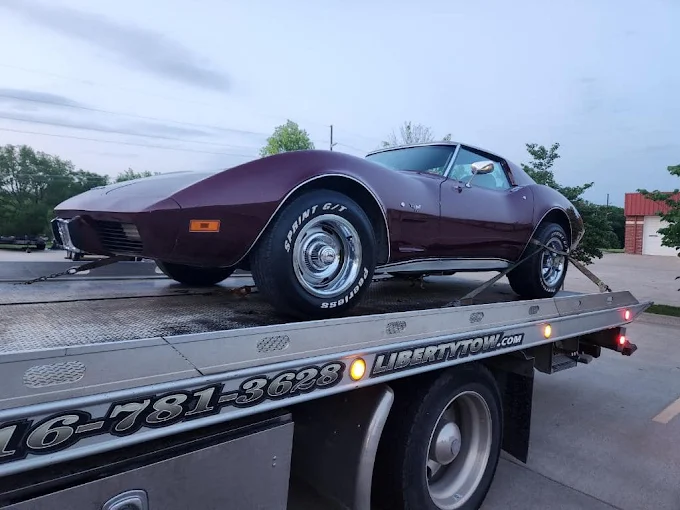 Liberty Tow with a classic corvette on the flatbed.